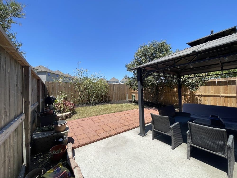 Clean paver patio and walkway at a Houston backyard after pressure washing